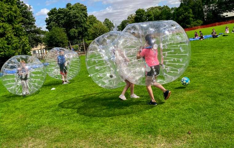 children doing zorbing