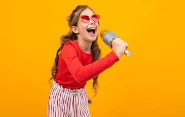 Girl singing in front of green screen